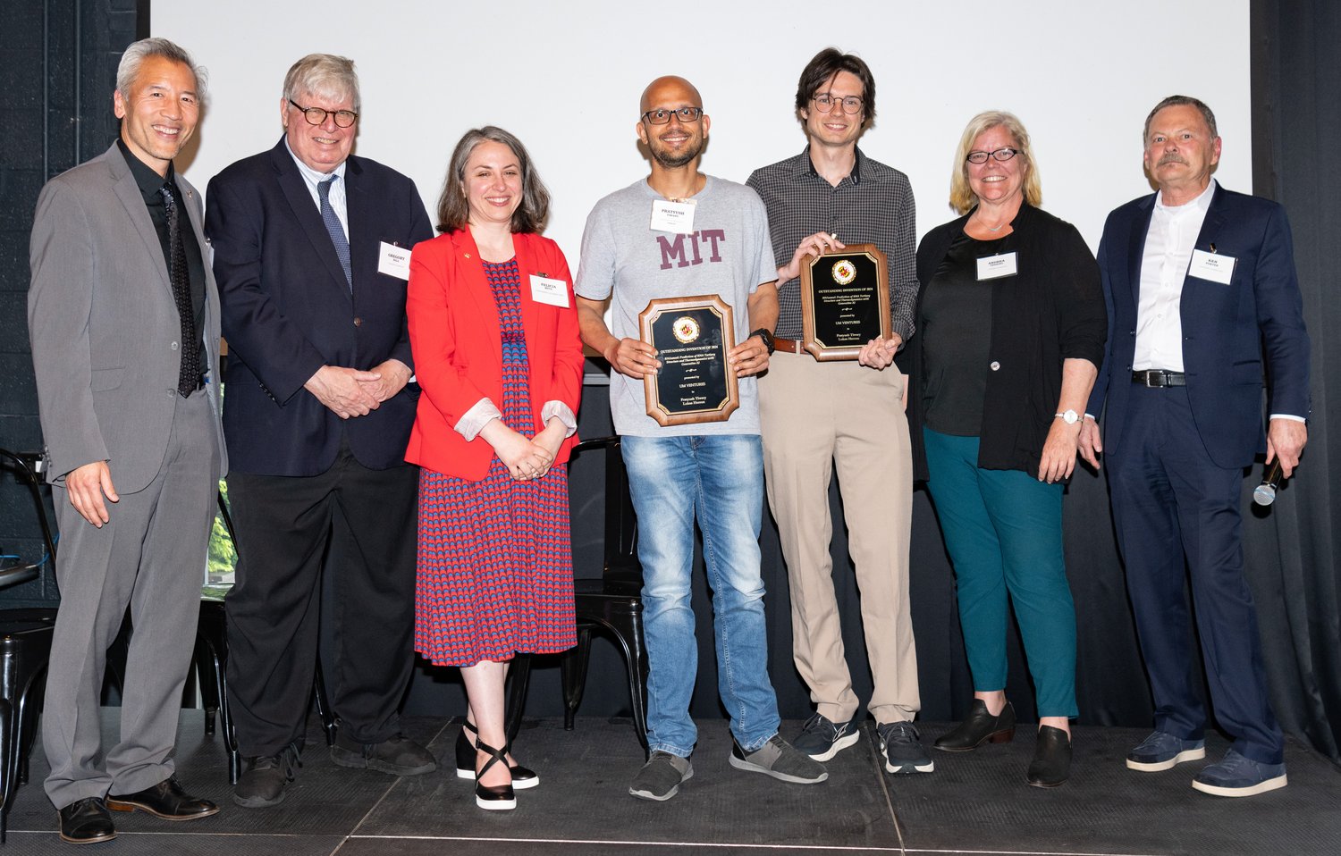 Pratyush Tiwary (center) and Lukas Herron receive the Life Sciences Invention of the Year Award. Photo by Mike Morgan