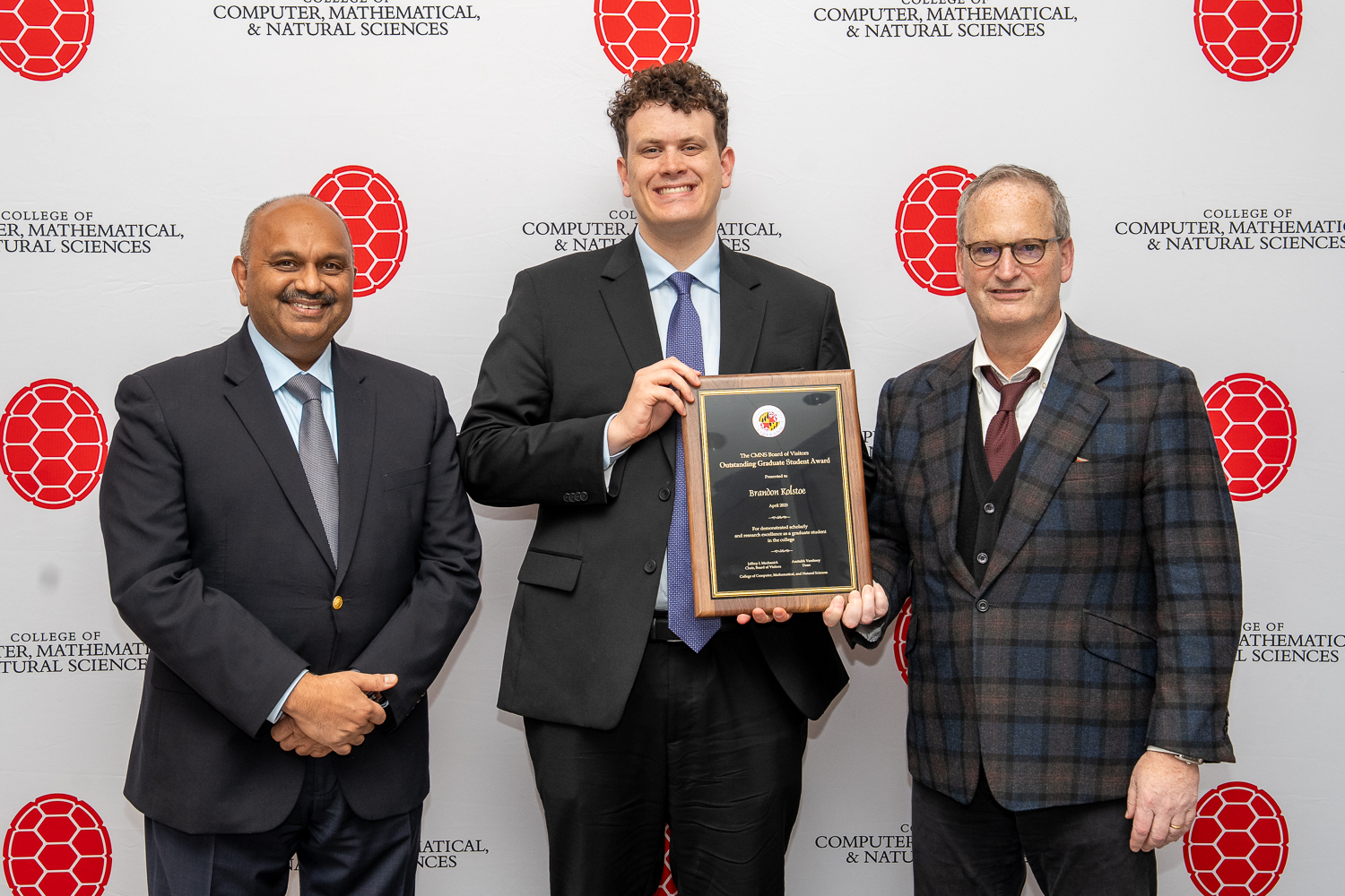 Amitabh Varshney, Brandon Kolstoe and Jeffrey Mechanick in front of CMNS branded backdrop