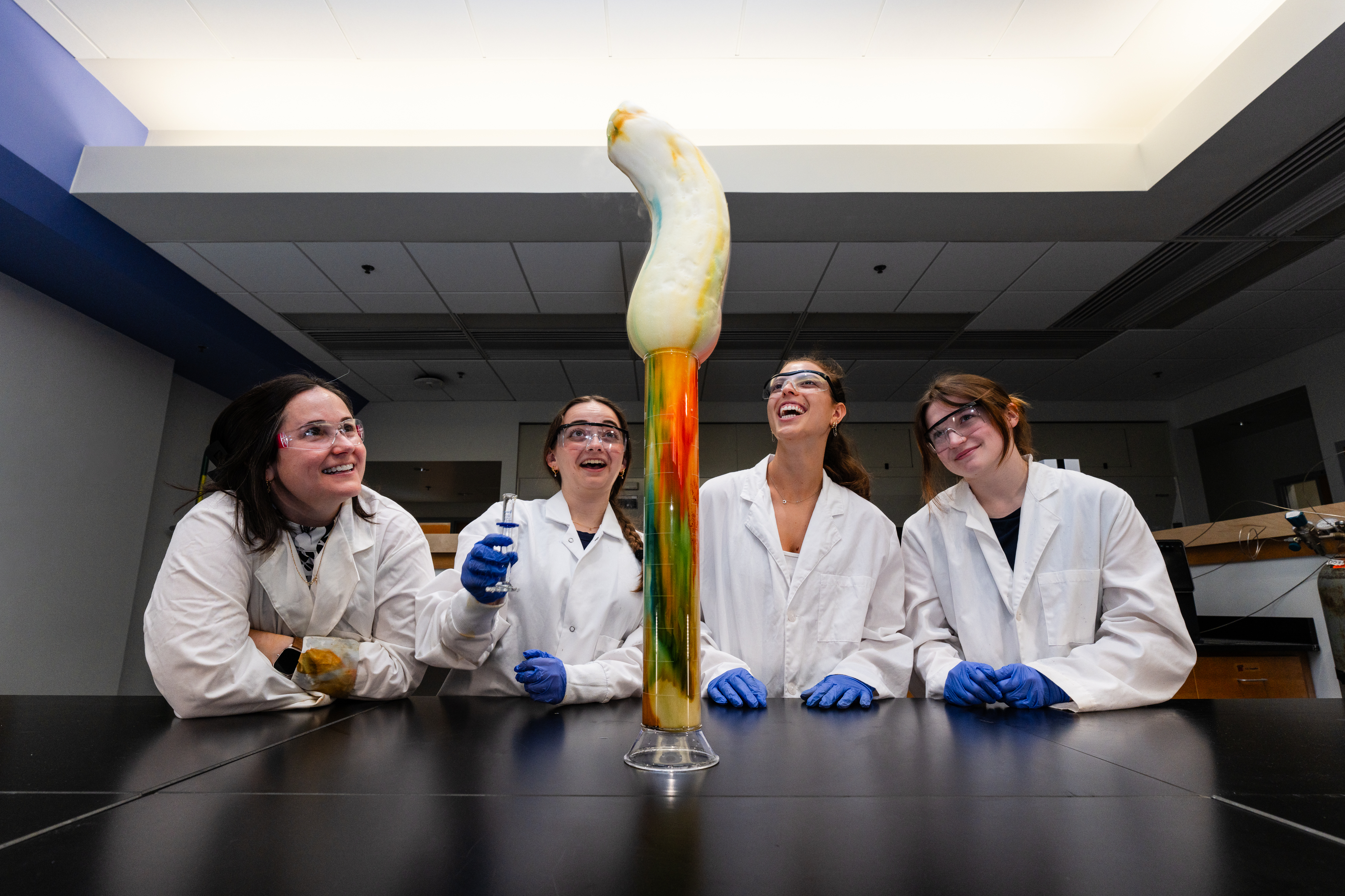 Lenea Stocker (left) and her students create a carbon snake