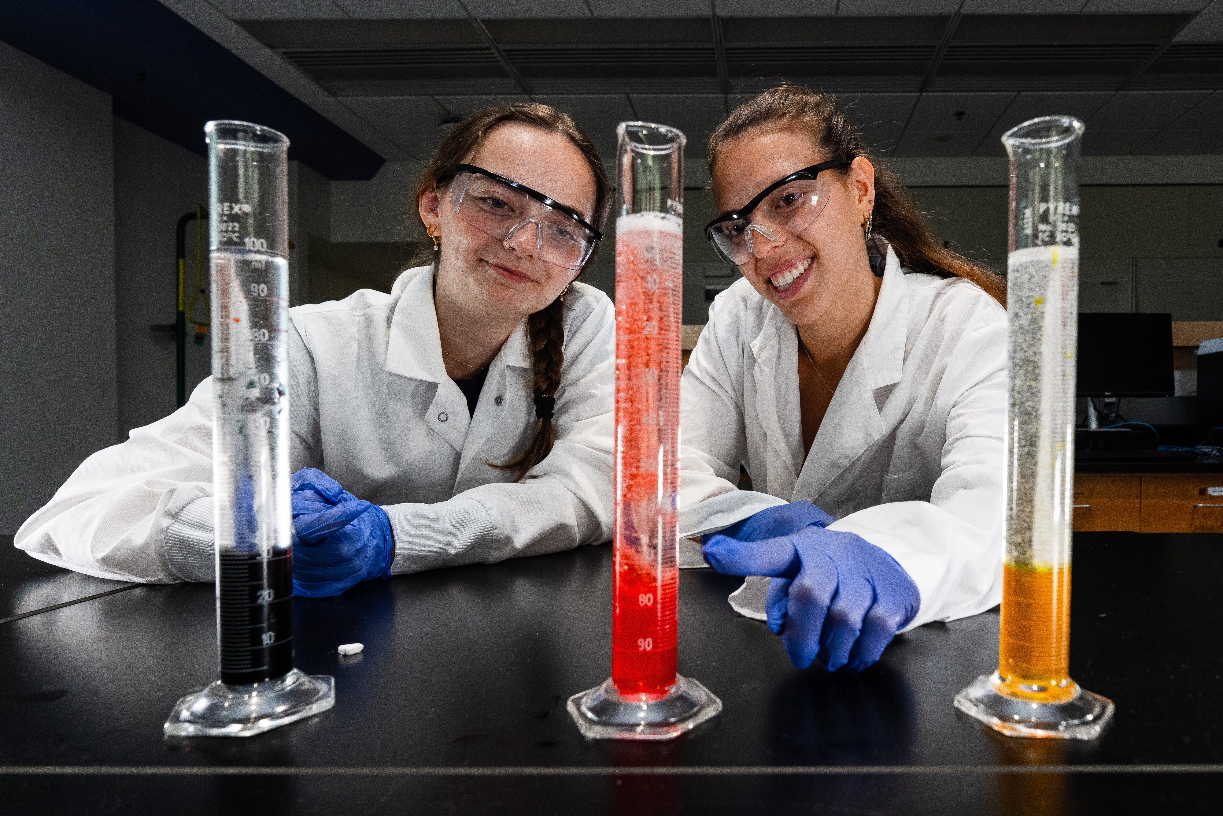 CHEM 316 students with brightly colored chemicals