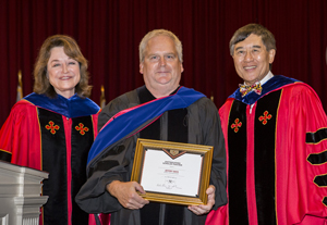 Jeffery Davis receiving his award from UMD President Wallace D. Loh and UMD Senior Vice President and Provost Mary Anne Rankin