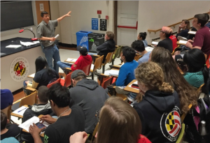 Tom Flores teaching students in a lecture hall
