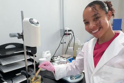Kaia Ungerer posing in a chemistry lab
