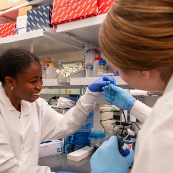 Ademide Adeyemo and Caroline Hobson collaborate at the lab bench.