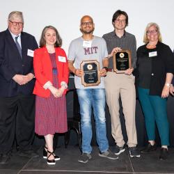 Pratyush Tiwary (center) and Lukas Herron receive the Life Sciences Invention of the Year Award. Photo by Mike Morgan